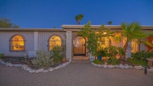 A two-story house with a brick facade, arched windows, and a gated entrance. - Poolside Oasis, Luscious Gardens, and Spacious 4-bedroom house in Tucson (Tucson)
