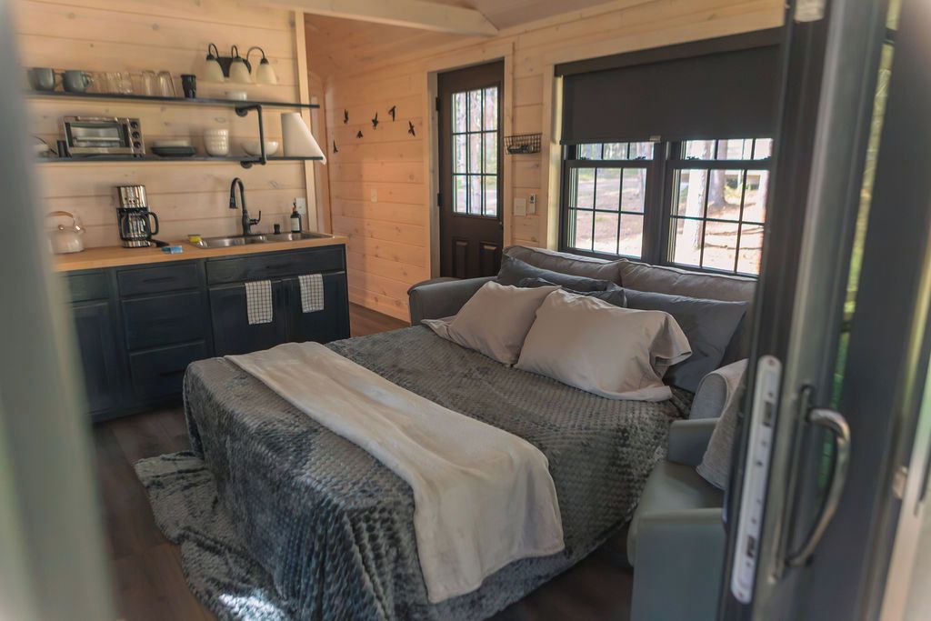 Une chambre confortable avec un lit, une commode et une fenêtre donnant sur un beau paysage.