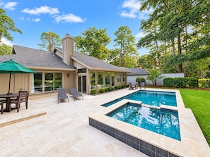 A residential backyard with a swimming pool, patio furniture, and a covered seating area. - 6 Wood Duck Court at The Sea Pines Resort (Hilton Head Island)