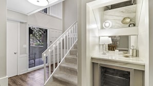 A modern interior with a staircase, a fireplace, and a dining area. - 965 Cutter Court at The Sea Pines Resort (Hilton Head Island)