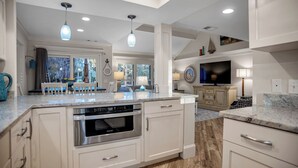 A modern kitchen with white cabinetry, stainless steel appliances, and pendant lighting. - 2426 Inland Harbour at The Sea Pines Resort (Hilton Head Island)