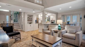 A spacious living area with a staircase, a kitchen, and a dining area. - 2426 Inland Harbour at The Sea Pines Resort (Hilton Head Island)
