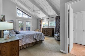 A bedroom with a bed, dresser, and a window with curtains. - 67 Forest Drive at The Sea Pines Resort (Hilton Head Island)