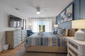 A bedroom with a bed, a dresser, a TV, and a ceiling fan. - 6966 Fairway One at The Sea Pines Resort (Hilton Head Island)