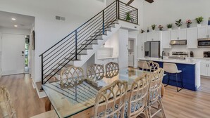 A modern kitchen with white cabinets, a blue island, and a stainless steel refrigerator. - 97 Fairway Lane at The Sea Pines Resort (Hilton Head Island)