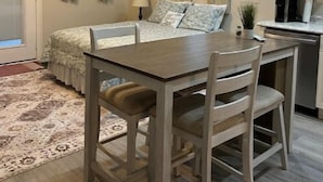 A compact bedroom with a bed, bedside table, and a ceiling fan. - Guest house in Hurricane Mills (Hurricane Mills)