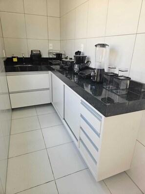 Mini-fridge, stovetop, cookware/dishes/utensils