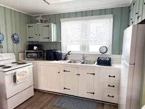 Fridge, microwave, stovetop, coffee/tea maker