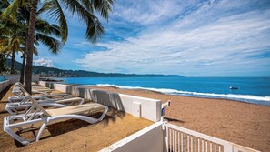 On the beach, sun-loungers, beach umbrellas, beach towels