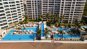 A resort with multiple swimming pools, palm trees, and a beach area. - Gorgeous 1BR with Pools & Sea Views (Puerto Vallarta)