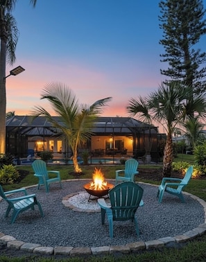 A patio area with a fire pit and outdoor seating.