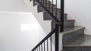 Eine Treppe mit schwarzen Metallgeländern und Granitstufen.