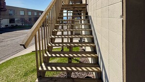 A wooden staircase leading to a building with a sign that reads "LAR TEMPLE".