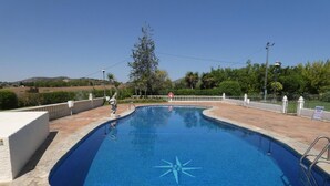 A swimming pool with a star-shaped design on the floor, surrounded by a white fence and trees. - Casa Rural del Jardin (Priego de Córdoba)