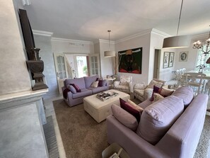 A living room with a sofa set, a coffee table, and a fireplace.
