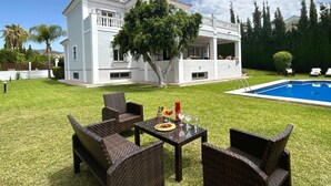 A two-story house with a swimming pool, outdoor furniture, and a tree in the yard. - Villa Maisa Luxury Marbella (Marbella)