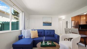 Family Apartment, 2 Bedrooms, Patio | Living area | 55-inch LED TV with digital channels