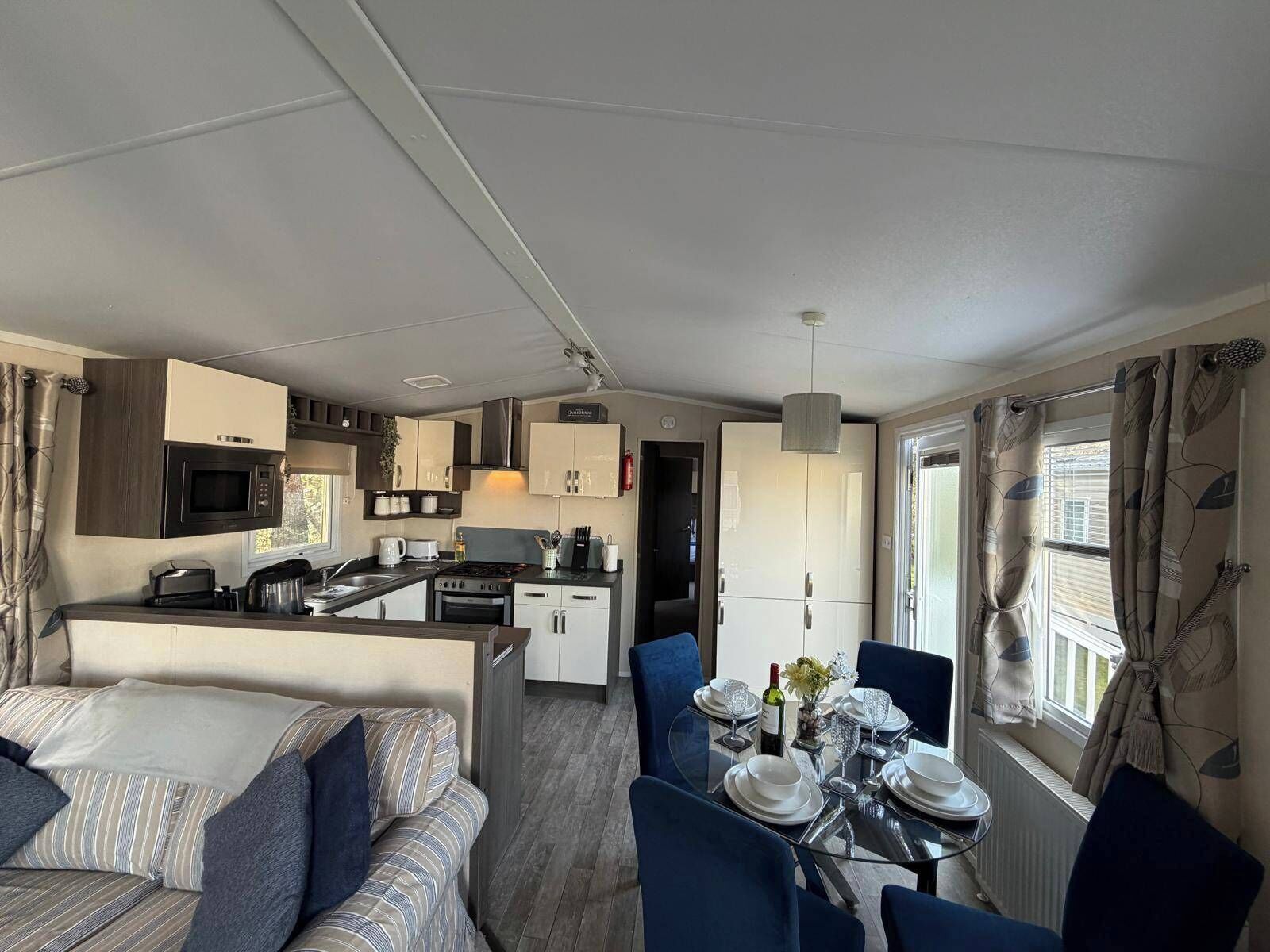A compact living space with a kitchenette, dining area, and a sofa.