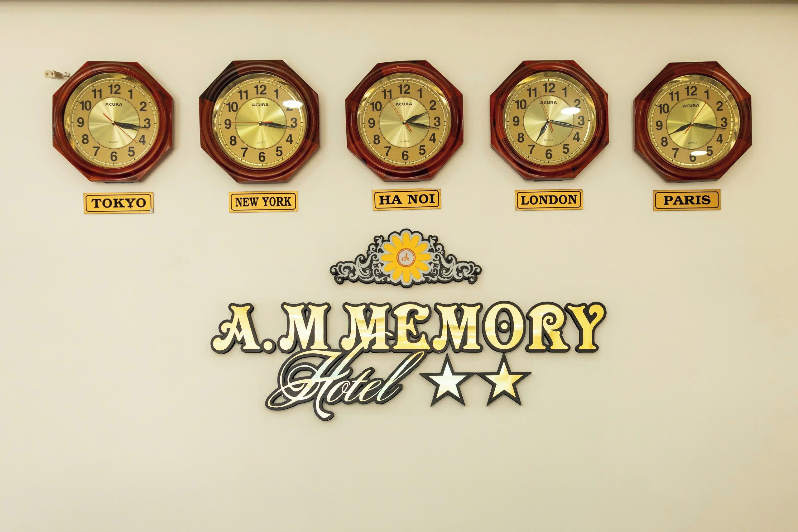 Five wall clocks labeled with city names: Tokyo, New York, Ha Noi, London, and Paris. Below the clocks is a sign that reads "A.M. MEMORY Hotel" with a sun and stars design.