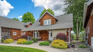 A two-story house with a front porch, a covered entryway, and a landscaped front yard with shrubs and a pathway. - Pet Friendly Dover Bay Getaway (Dover)