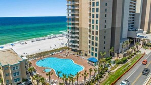 A hotel with a pool, beach access, and a view of the ocean.