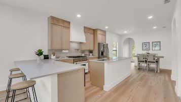 Enjoy cooking in this well-lit kitchen with a central island and ample workspace.