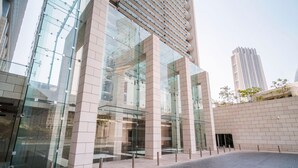 A modern building with large glass windows and a brick facade.