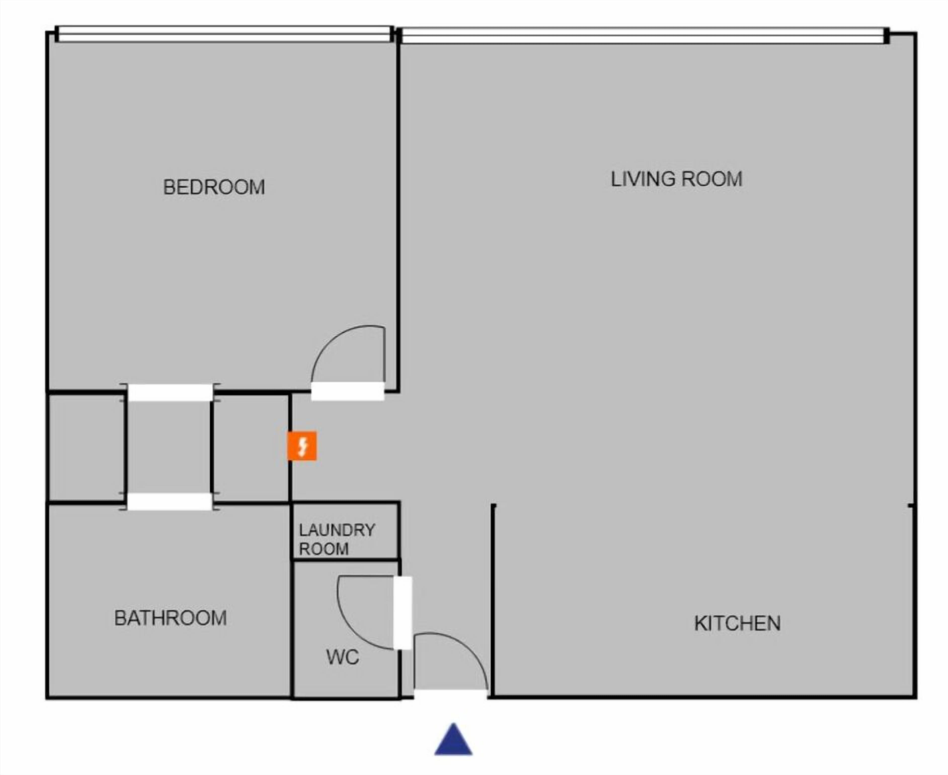 Un plano de planta que muestra un dormitorio, sala de estar, baño, lavandería y cocina.