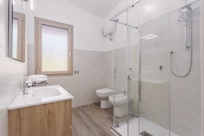 Een douche, een haardroger, een bidet, handdoeken