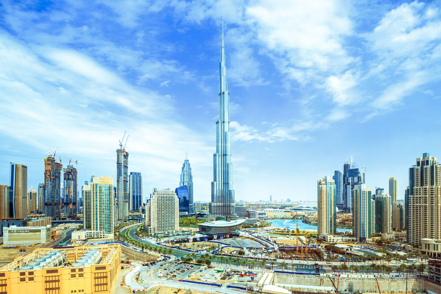 A cityscape with a prominent skyscraper, various modern buildings, and a busy urban environment.