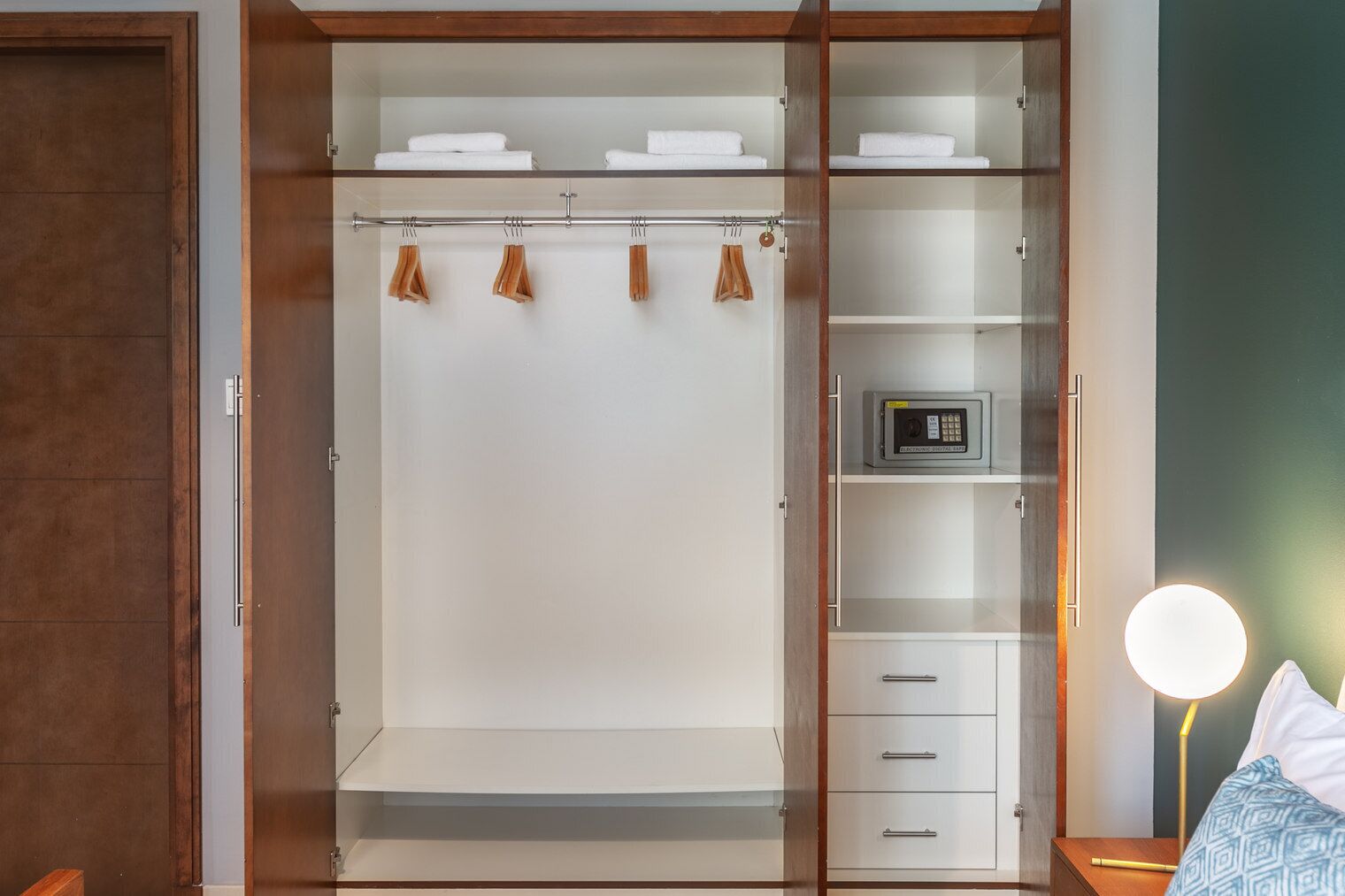 A walk-in closet with hanging space, shelves, and drawers.