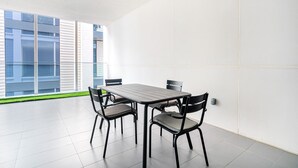 A modern room with a large window, a table, and four chairs. - Blueground | City Walk, pool, nr City Park (Dubai)