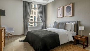 Une chambre moderne avec un grand lit, un bureau et une chaise.