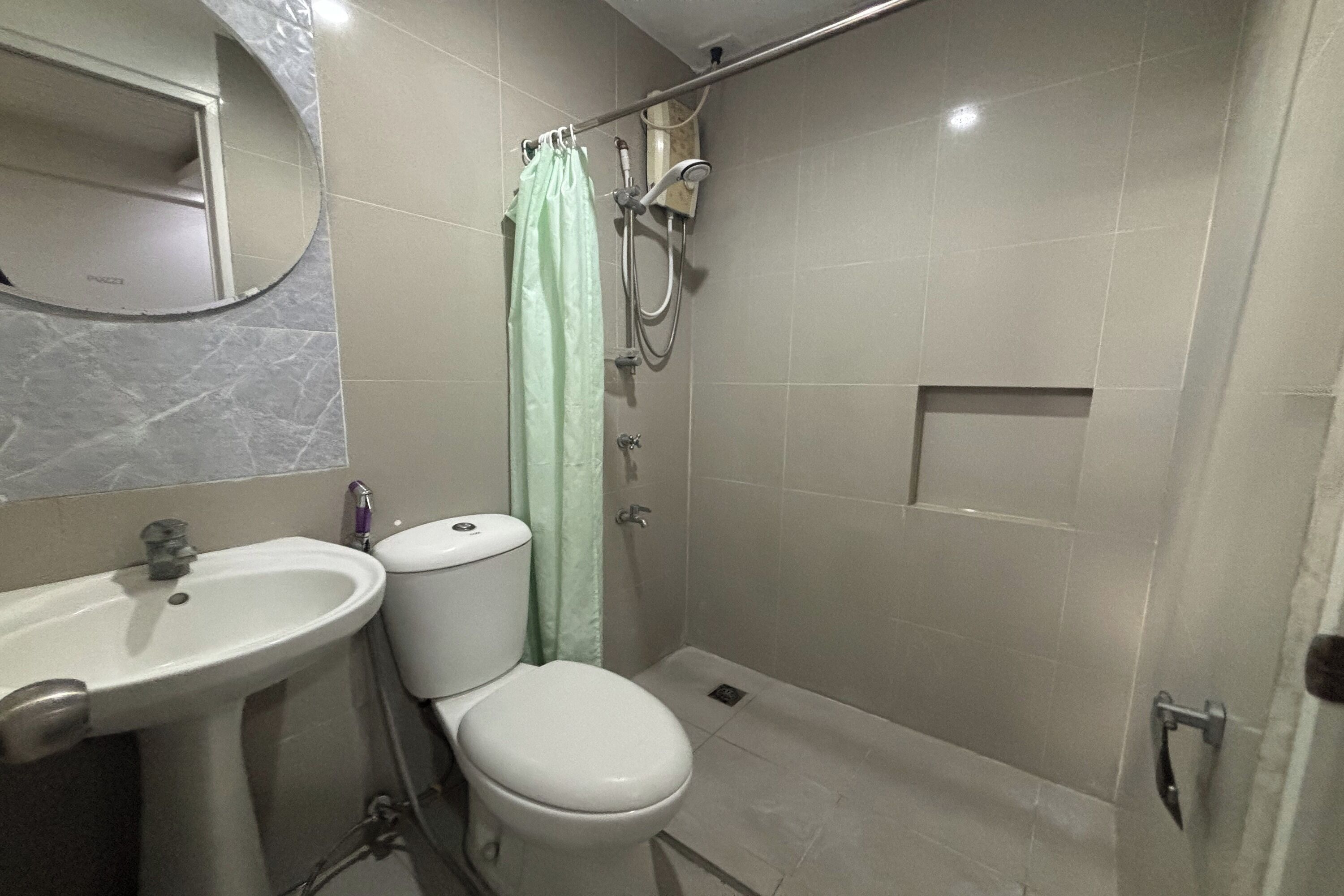A bathroom with a sink, toilet, and shower.
