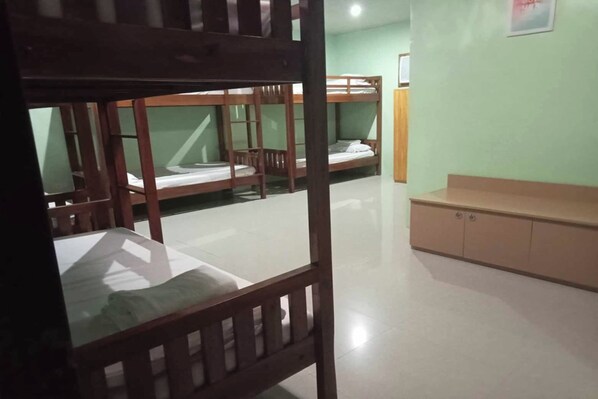 A dormitory room with bunk beds, a wooden desk, and a cabinet. - Galucksea Beach Resort (Lagonglong)