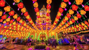 A traditional building with a multi-tiered roof, surrounded by a festive display of lanterns and lights. - Feringghi Stay Iinn (George Town)
