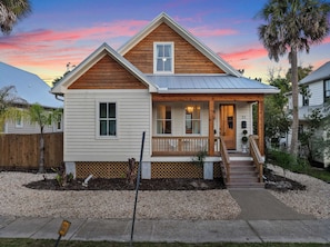 A two-story house with a front porch, a visible mailbox, and a number '31' on the house.