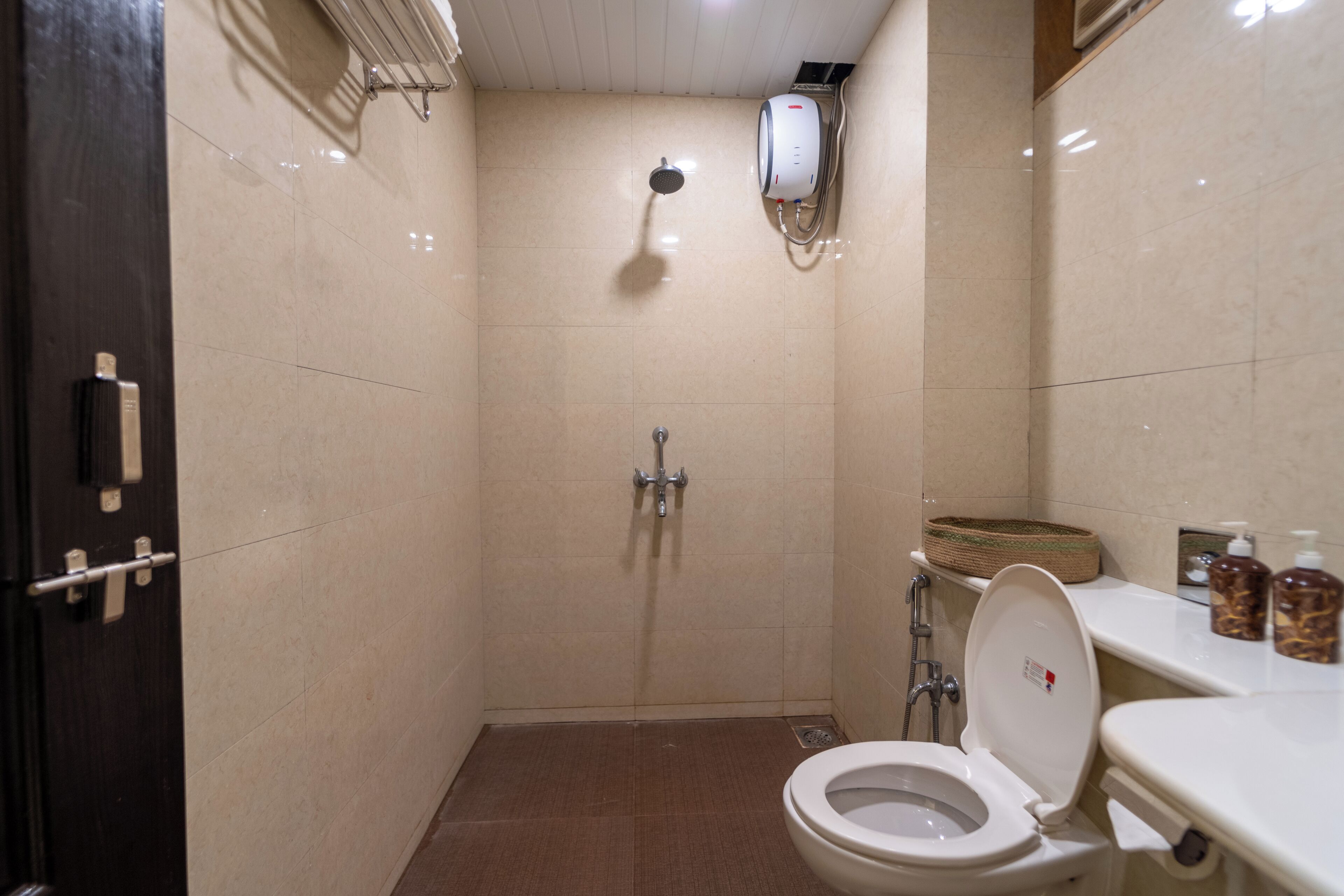 A small, compact bathroom with a shower, toilet, and sink.