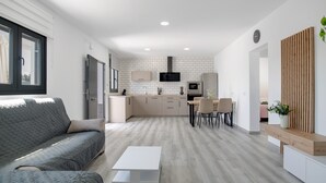A modern kitchen with white tiles, a built-in oven, and a microwave. - Holiday Home 'El Rincón Del Sur 2' with Private Pool, Wi-Fi and Air Conditioning (Barrio Nuevo)