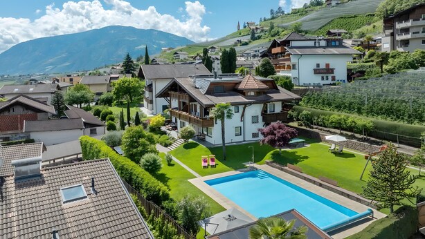 A residential property with a swimming pool, lush garden, and a mountainous backdrop. - Apartment 'Christine 1' with Mountain View, Shared Pool and Wi-Fi (Riffian)