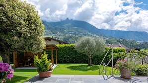 A patio with stone flooring, a wooden pergola, and potted plants. - Apartment 'Christine 1' with Mountain View, Shared Pool and Wi-Fi (Riffian)