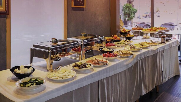 A buffet table with various food items and a self-service station. - Bazaar Hotel  (Tirana)