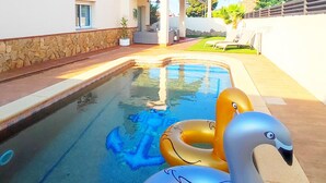 Una piscina con flotadores de cisne e delfín inflables.