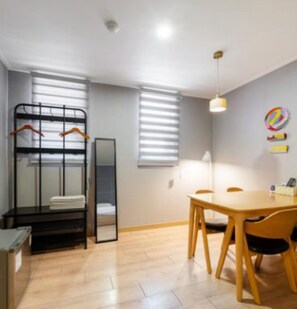 Family Quadruple Room | Living area | 0-inch flat-screen TV with cable channels, heated floors