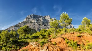 A mountainous landscape with rocky terrain and green vegetation.