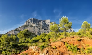 A mountainous landscape with rocky terrain and green vegetation.