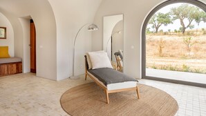 A bedroom with a bed, a floor lamp, a large window, and a view of the outdoors. - Holiday Home 'Monte De Santiago' with Mountain View, Private Pool and Wi-Fi (São Domingos)