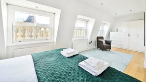 Una camera da letto moderna con un letto grande, una sedia e un armadio.