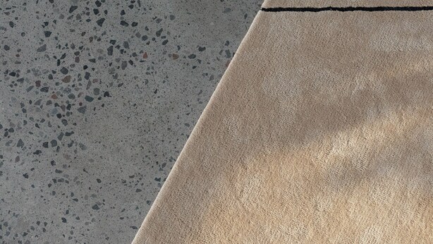 A section of a terrazzo floor with a contrasting beige tile. - Nova by OXO (Canggu)