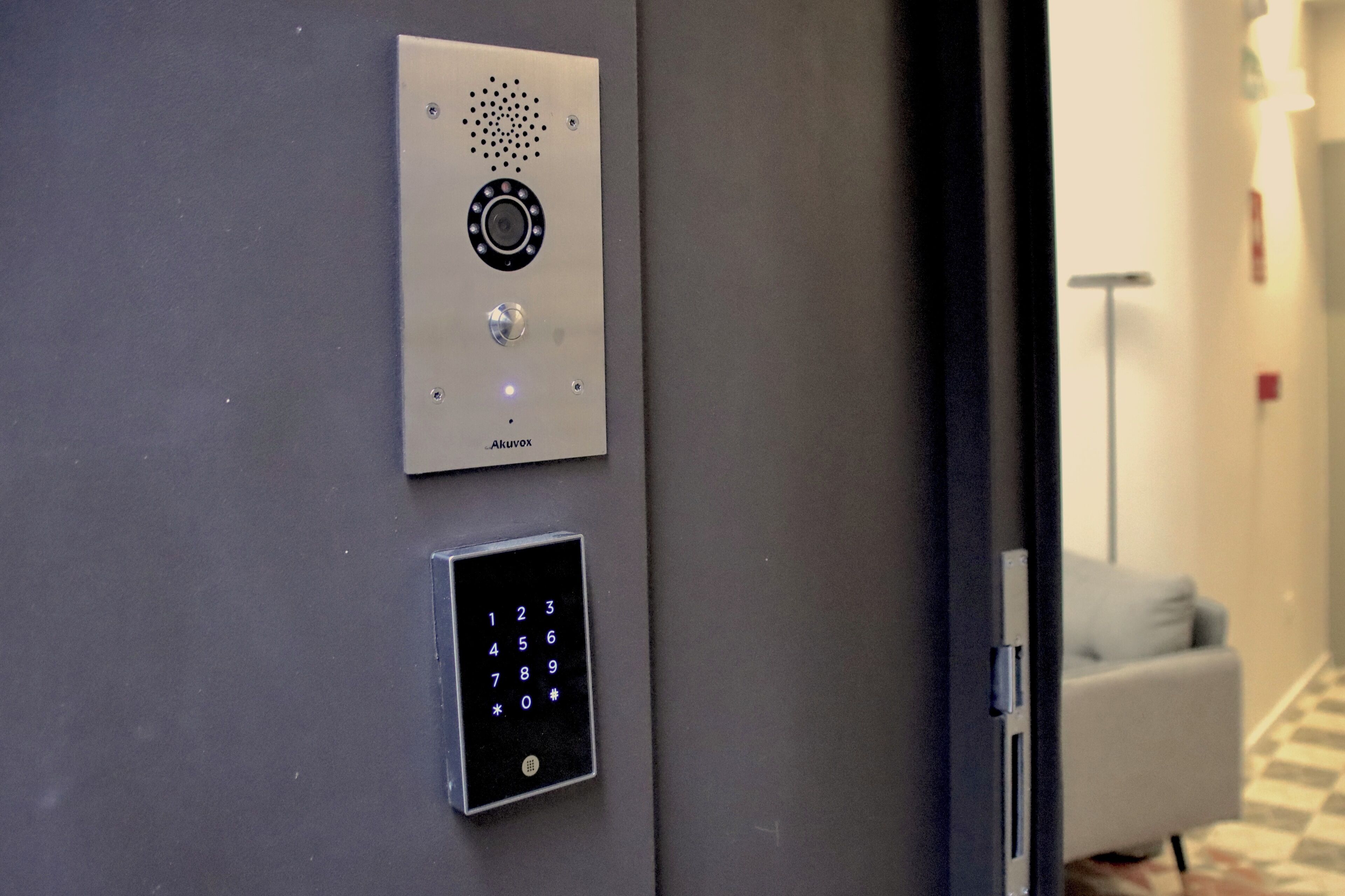 A wall-mounted elevator control panel with a numeric keypad and a circular interface.